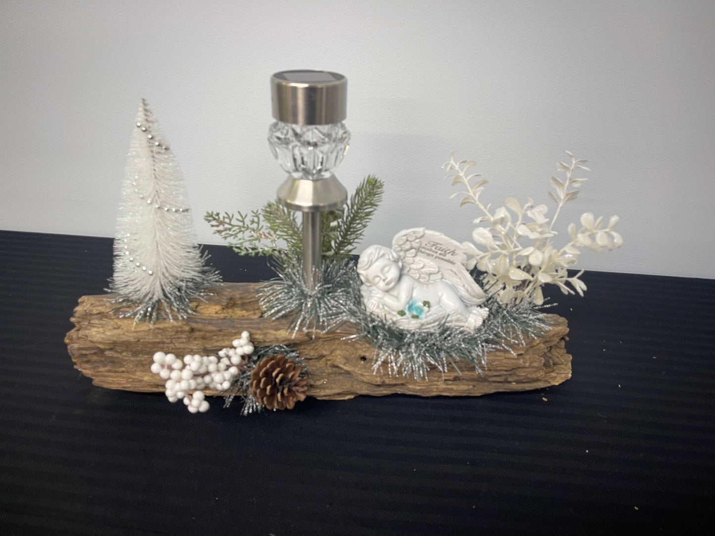 Angel with light on driftwood